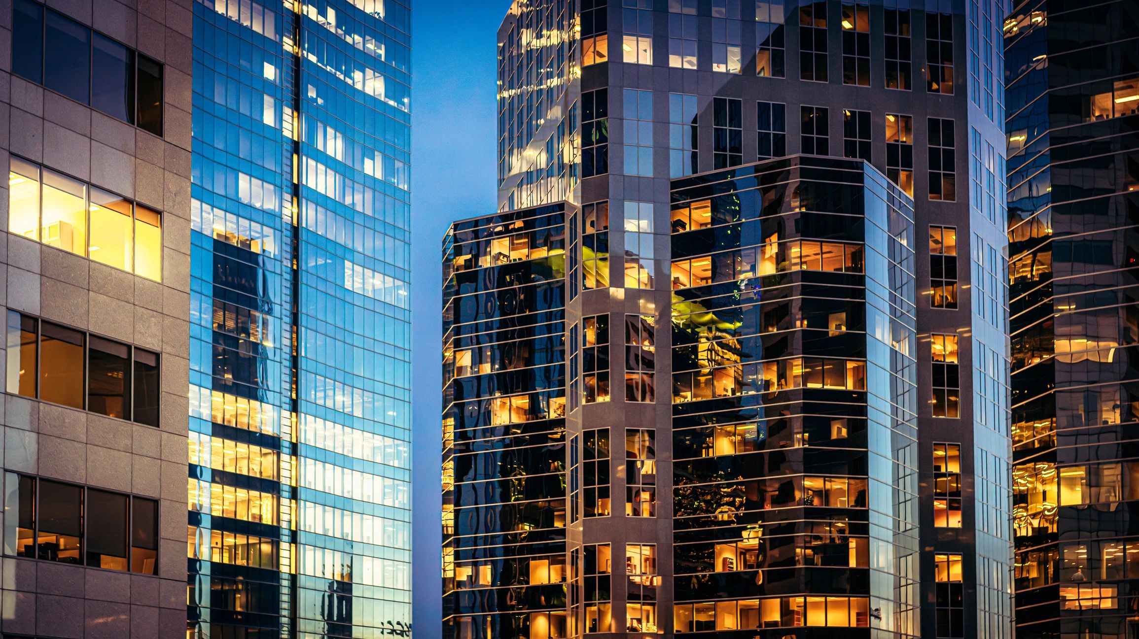 Modern glass office towers at dusk