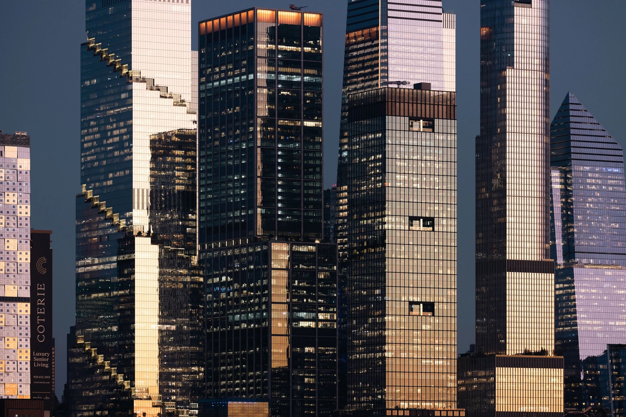 Reflections on high-rise facades at dusk